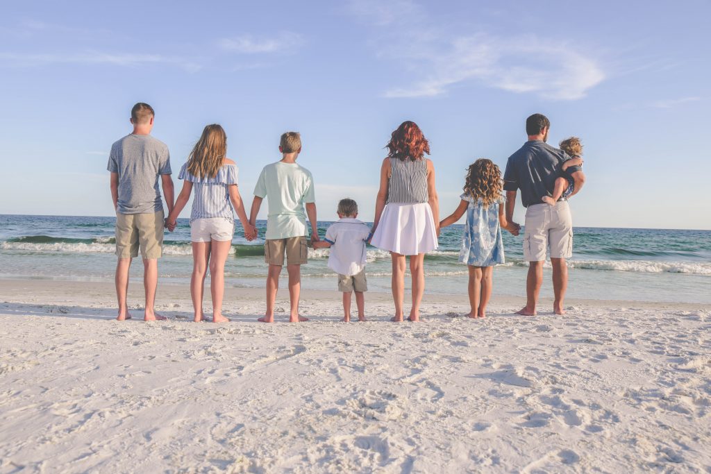 Family holding hands while enjoying the scenery of the Gulf of Mexico