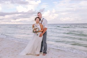 Groom holding bride on the beach in Destin, FL