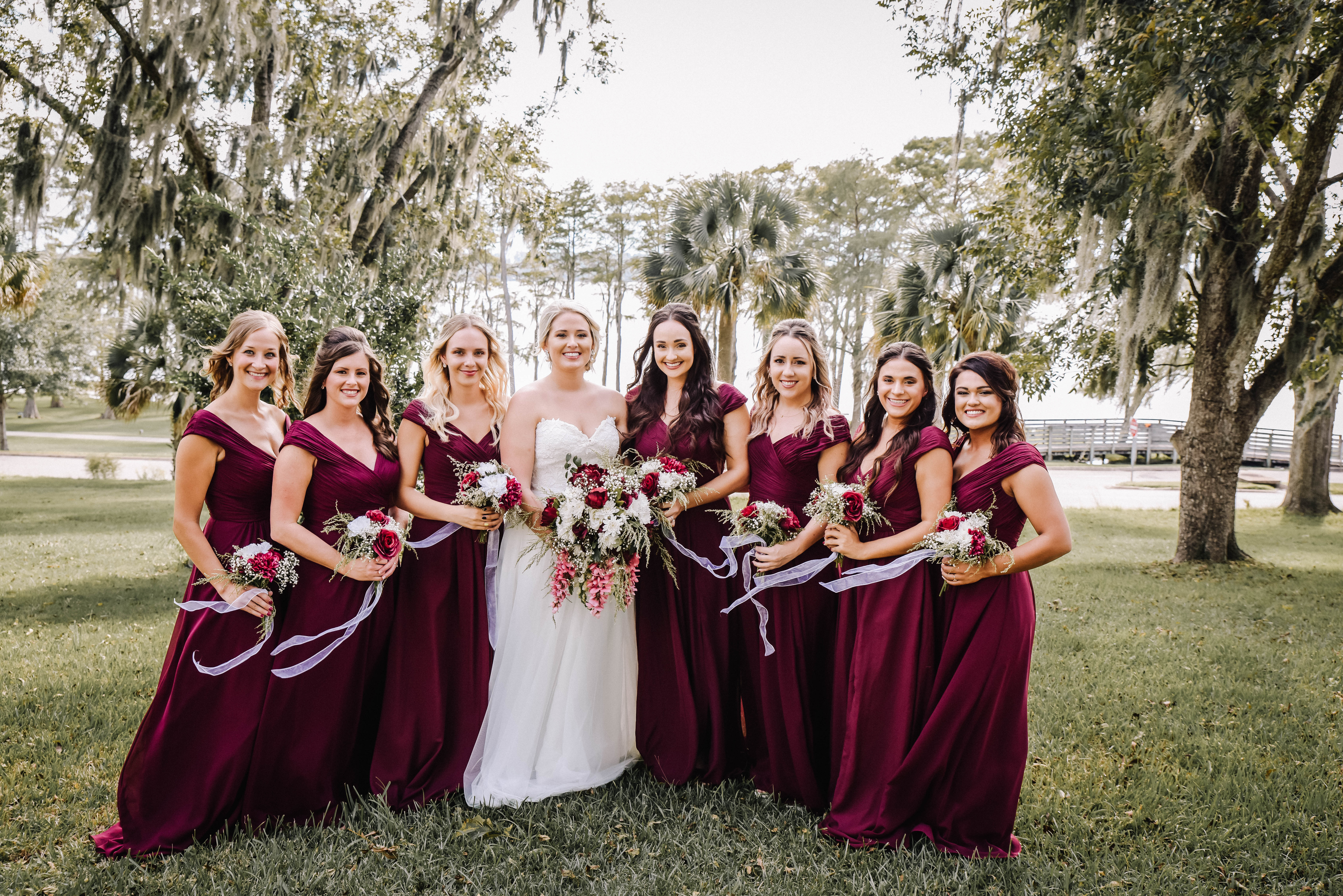 Bride posing with bridesmaids with boquets
