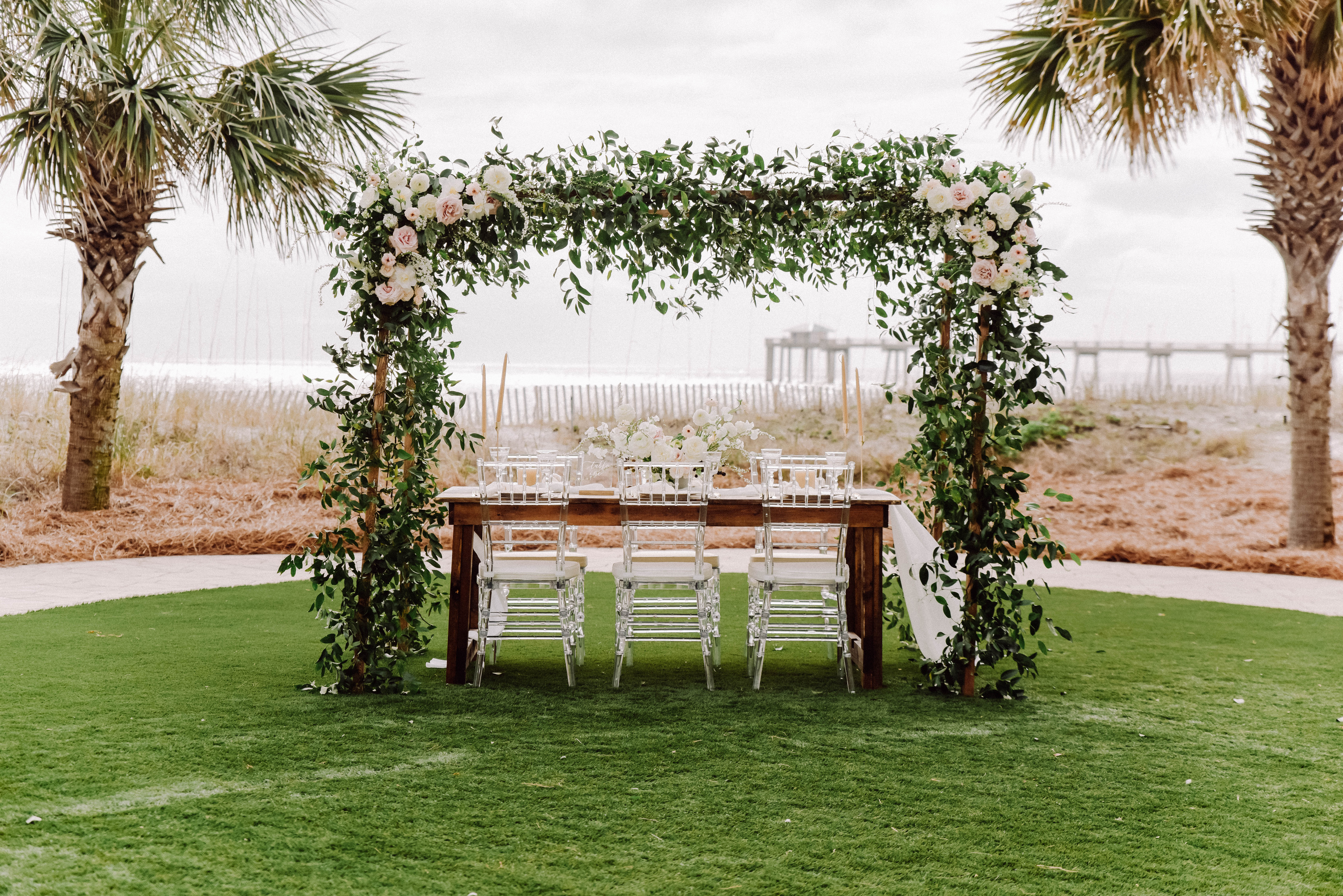 Wedding reception table set on the green lawn at The Island Hotel in Fort Walton Beach, FLorida