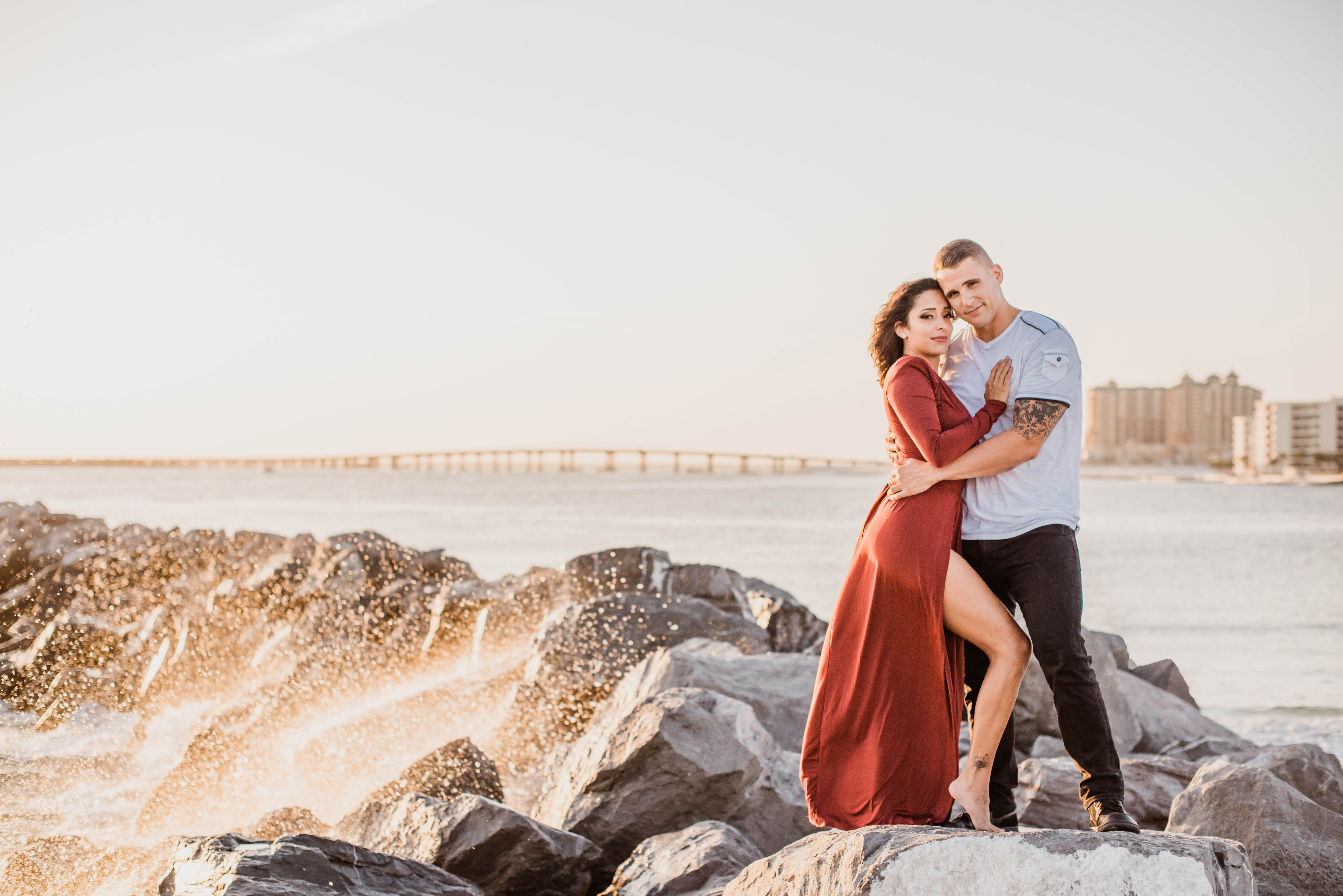 Engaged couple standing on the Destin Florida jetties for engagement session