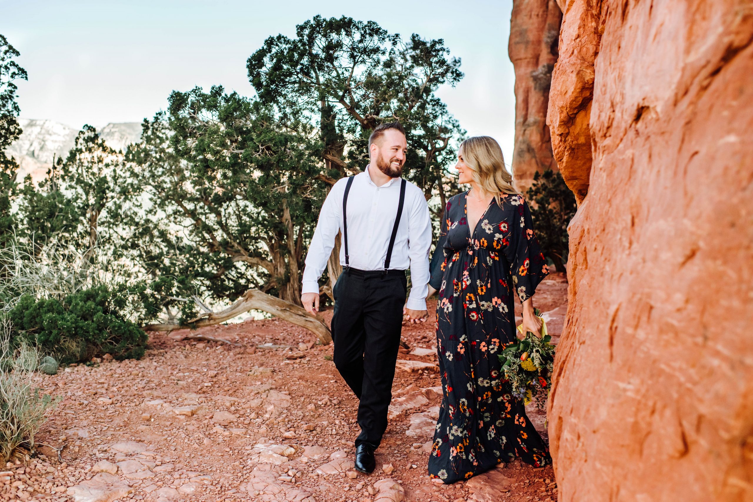 Elopement photographer captures newlyweds holding hands at Cathedral Rock in Sedona, AZ