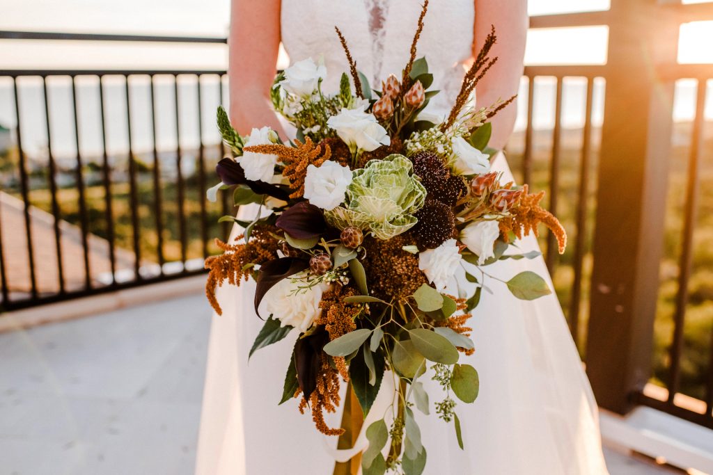 Bride holding a beautiful unique bridal bouquet for a wedding at the Henderson beach Resort in Destin, Florida
